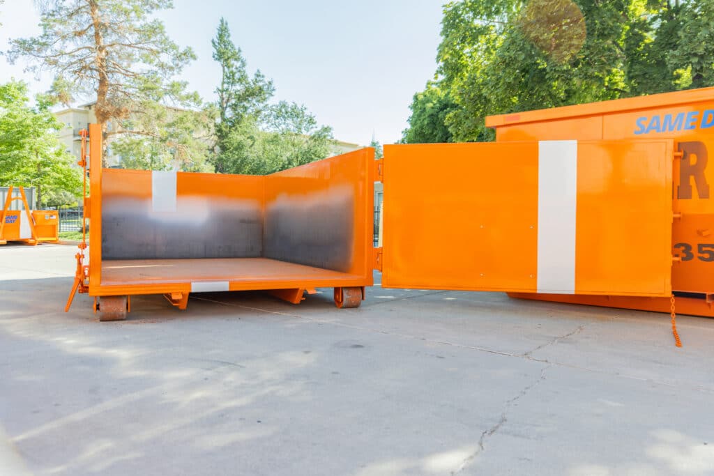 A Same Day Dumpster truck parked in a parking lot.