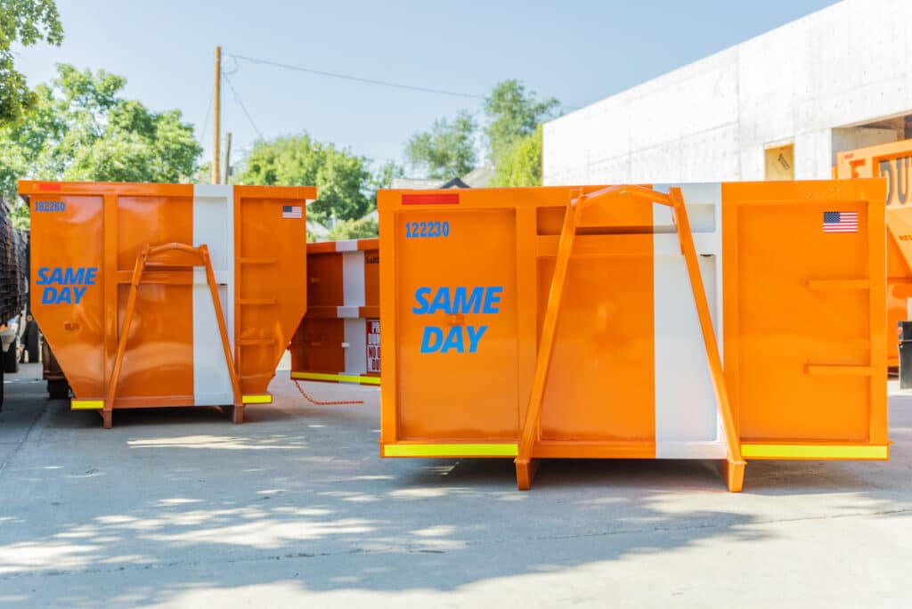 Same day dumpster rental parked in front of a building.