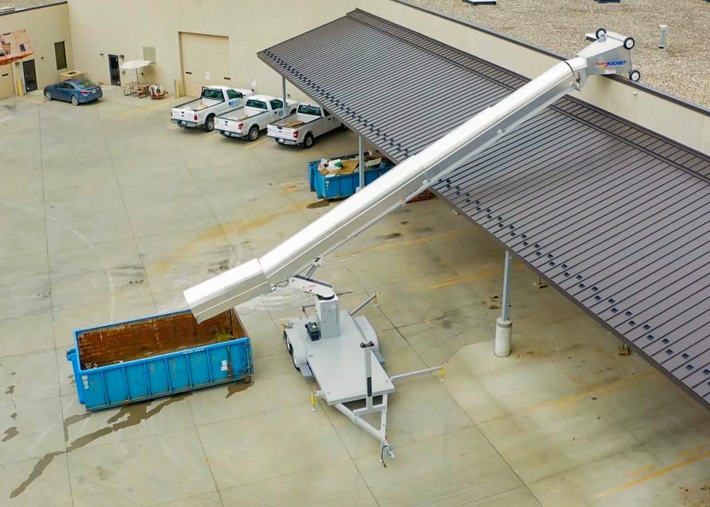 A man standing in front of a 12 yard dumpster provided by Sameday Dumpster